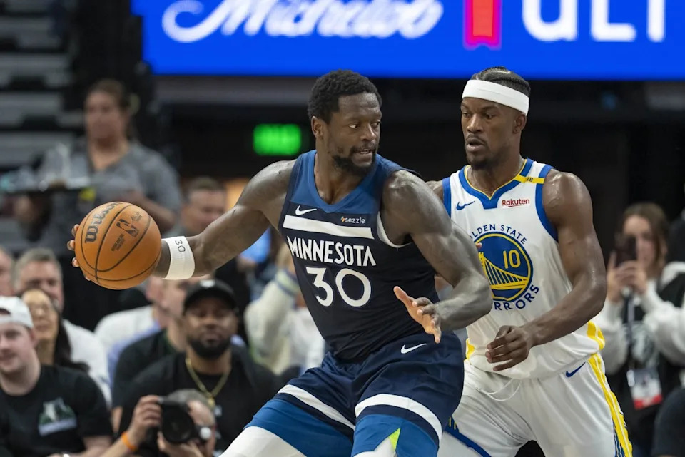 Minnesota Timberwolves forward Julius Randle operates with the ball as Golden State Warriors forward Jimmy Butler defends during their playoff game at Target Center on May 14, 2025.Jesse Johnson-Imagn Images