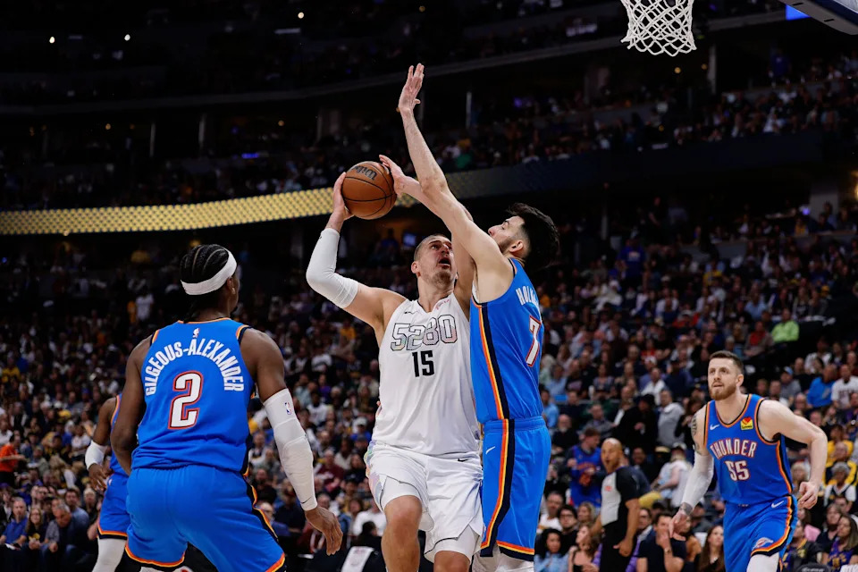 May 15, 2025; Denver, Colorado, USA; Denver Nuggets center Nikola Jokic (15) drives to the net against Oklahoma City Thunder forward Chet Holmgren (7) as guard Shai Gilgeous-Alexander (2) defends in the third quarter during game six of the second round for the 2025 NBA Playoffs at Ball Arena. Mandatory Credit: Isaiah J. Downing-Imagn Images