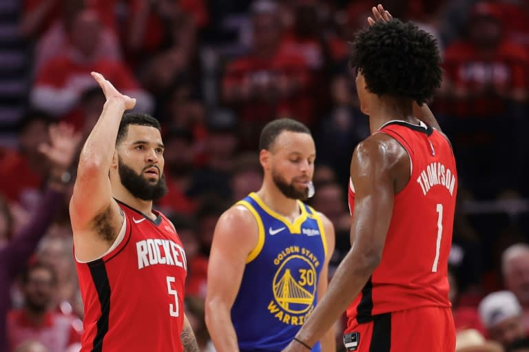 Fred VanVleet and Amen Thompson of the Houston Rockets high five in front of Golden State star Stephen Curry during the Rockets' victory over the Warriors in game five of their NBA playoff series (Alex Slitz)