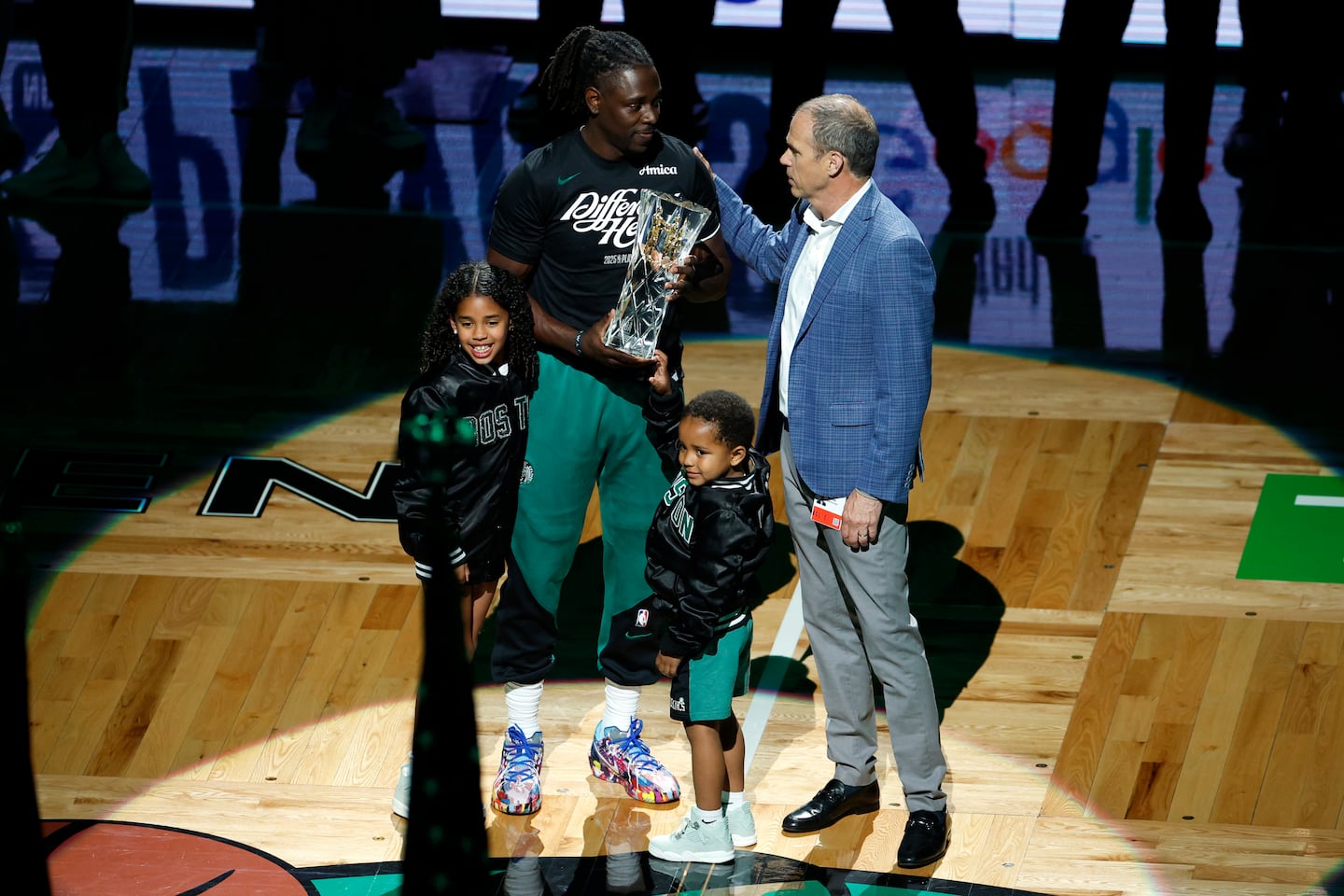 Boston Celtics guard Jrue Holiday receives the sportsmanship award with his children Jrue, left, and Hendrix before game two.