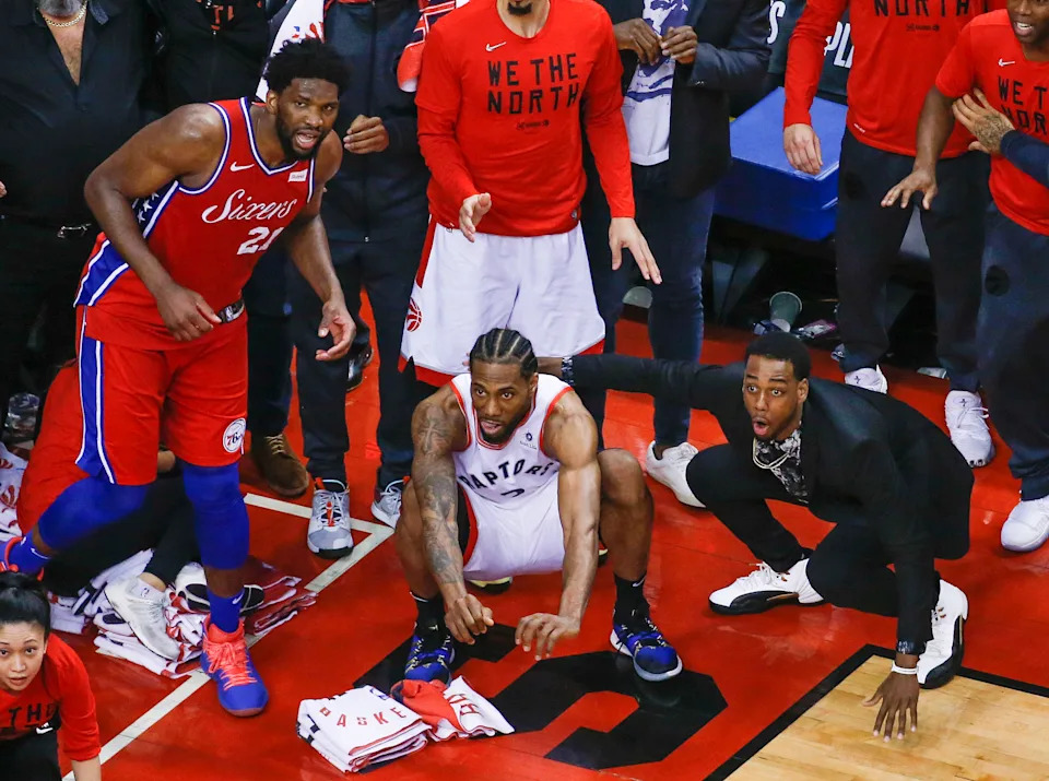 TORONTO, ON - MAY 12: Philadelphia 76ers center Joel Embiid (21) watches from the corner as Toronto Raptors forward Kawhi Leonard (2) squats down and sticks out his tongue waiting for the ball to drop for Raptors to win. Toronto Raptors vs Philadelphia 76ers in2nd half action of Round 2, Game 7 of NBA playoff play at Scotiabank Arena. . Toronto Star/Rick Madonik        (Rick Madonik/Toronto Star via Getty Images)