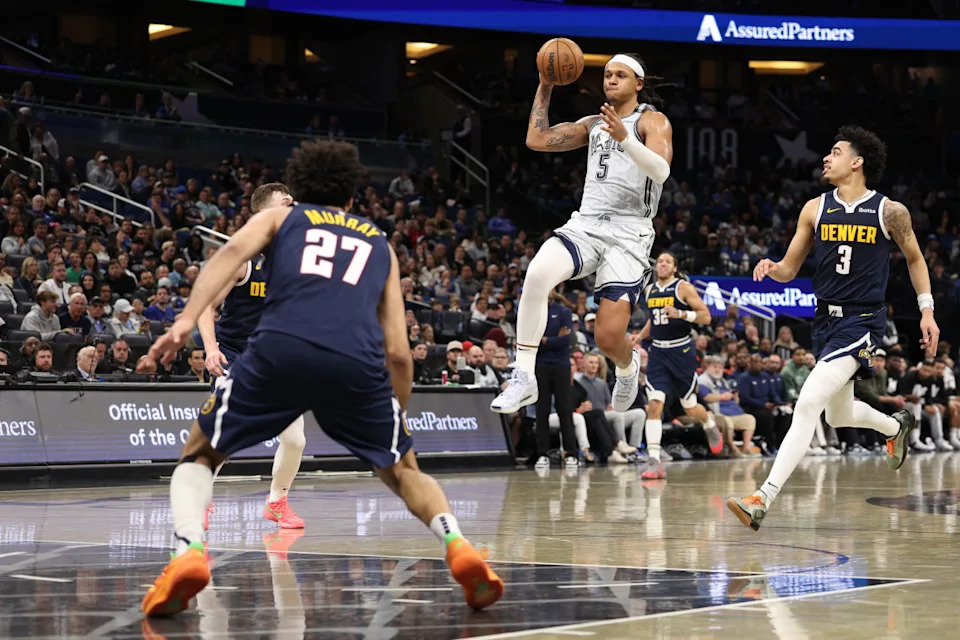 Orlando Magic forward Paolo Banchero passes the ball against the Denver Nuggets in the fourth quarter at Kia Center.Nathan Ray Seebeck-Imagn Images