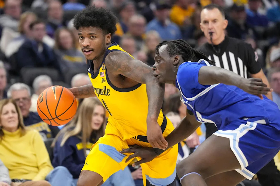 Feb 18, 2025; Milwaukee, Wisconsin, USA; Marquette Golden Eagles guard Kam Jones (1) dribbles the ball under pressure from Seton Hall Pirates guard Garwey Dual (33) during the second at Fiserv Forum. Mandatory Credit: Jeff Hanisch-Imagn Images