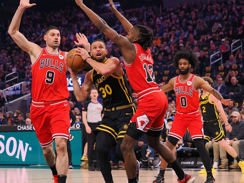 Mar 7, 2024; San Francisco, California, USA; Golden State Warriors guard Stephen Curry (30) drives between Chicago Bulls center Nikola Vucevic (9) and guard Ayo Dosunmu (12) during the first quarter at Chase Center. © Kelley L Cox-Imagn Images