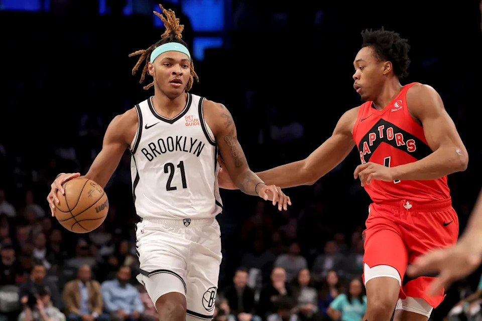 Mar 26, 2025; Brooklyn, New York, USA; Brooklyn Nets forward Noah Clowney (21) brings the ball up court against Toronto Raptors forward Scottie Barnes (4) during the first quarter at Barclays Center. Mandatory Credit: Brad Penner-Imagn Images