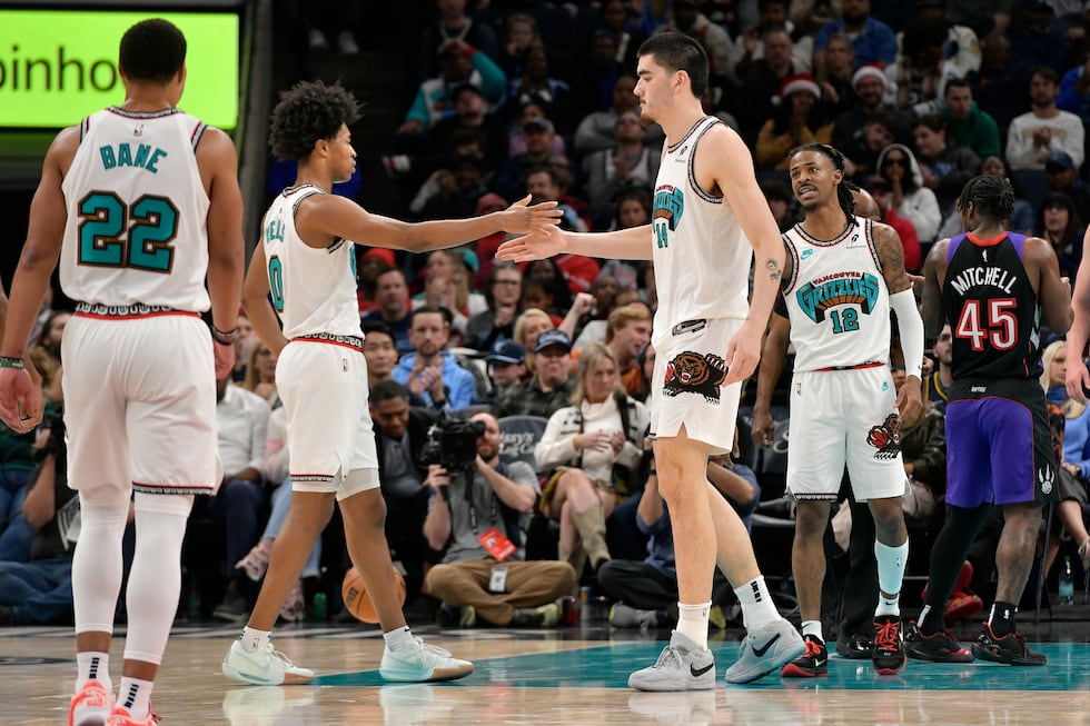 Memphis Grizzlies forward Jaylen Wells (0) high fives center Zach Edey (14) in the first half...