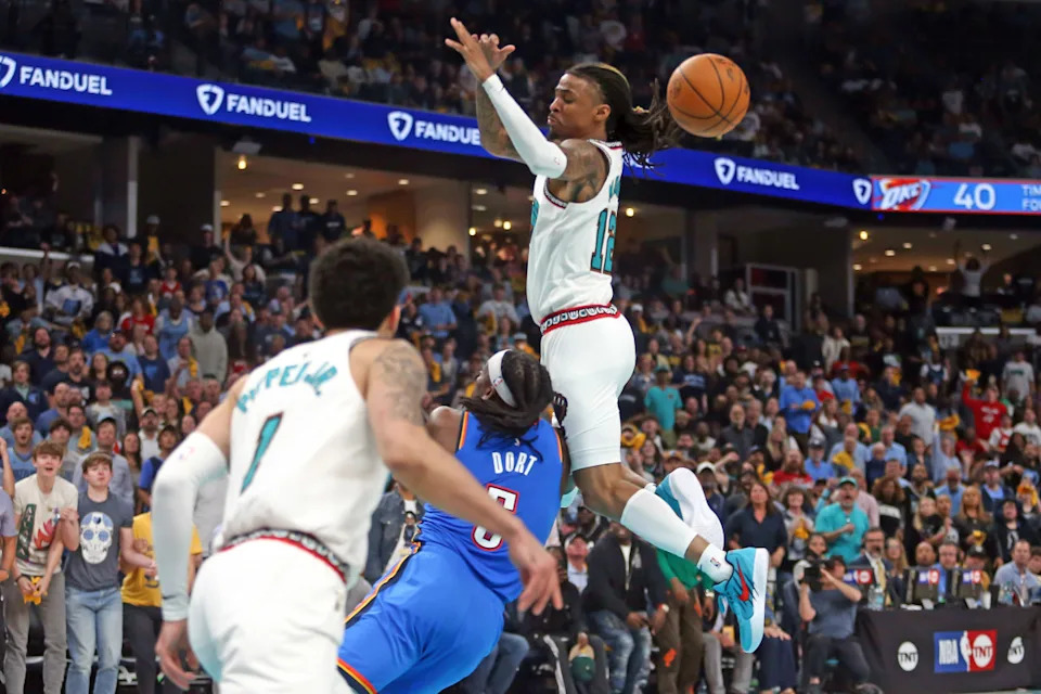Memphis Grizzlies guard Ja Morant (12) and Oklahoma City Thunder guard Luguentz Dort (5).Petre Thomas-Imagn Images