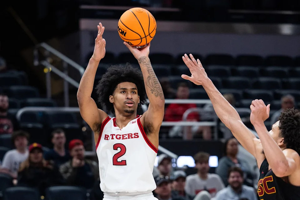 Mar 12, 2025; Indianapolis, IN, USA; Rutgers Scarlet Knights guard Dylan Harper (2) shoots the ball while USC Trojans guard Desmond Claude (1) defends in the second half at Gainbridge Fieldhouse. Mandatory Credit: Trevor Ruszkowski-Imagn Images