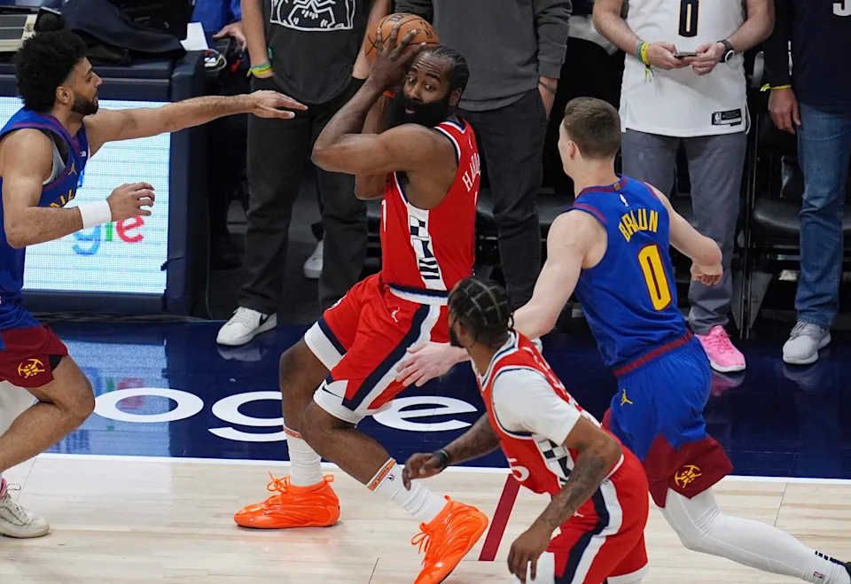 The Clippers' James Harden, top center, looks to pass the ball to teammate Derrick Jones Jr. between two Nuggets defenders.