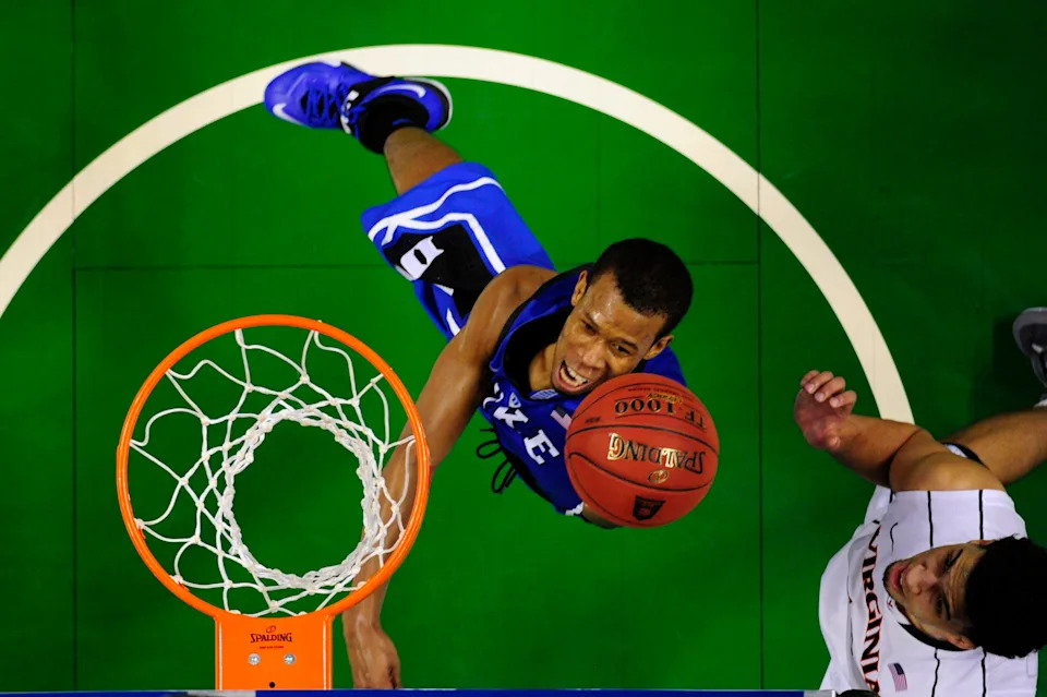 Duke Blue Devils forward Rodney Hood shoots as Virginia Cavaliers forward Anthony Gill defends.