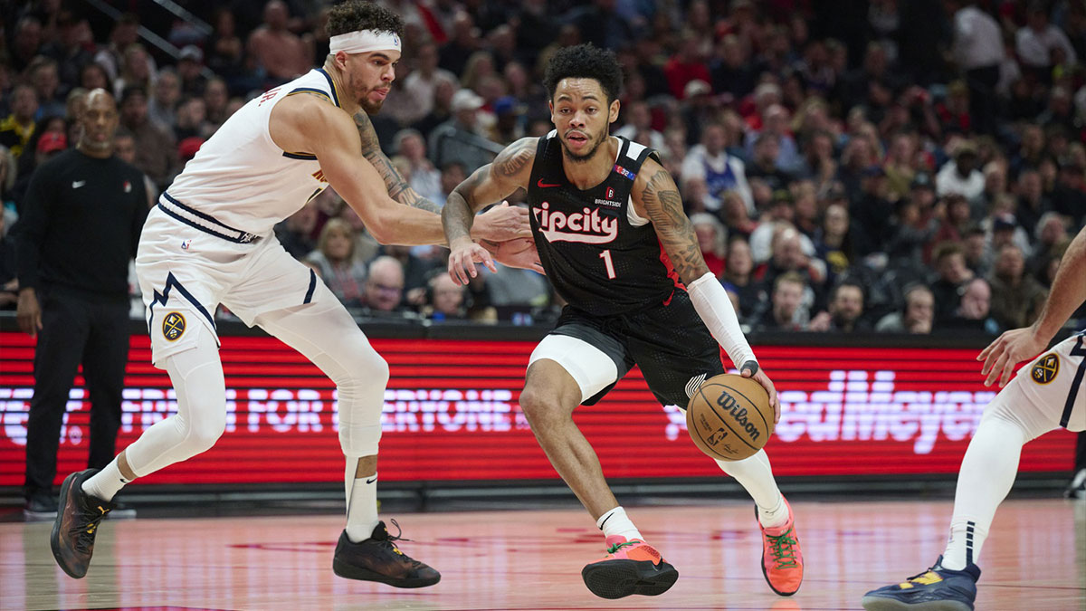 Portland Trail Blazers guard Anfernee Simons (1) drives to the basket during the first half against Denver Nuggets forward Michael Porter Jr. (1) at Moda Center. 