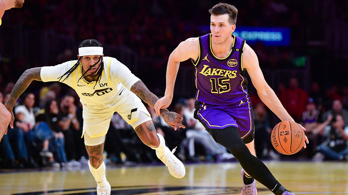 Los Angeles Lakers guard Austin Reaves (15) moves the ball against Utah Jazz guard Jordan Clarkson (00) during the first half at Crypto.com Arena.