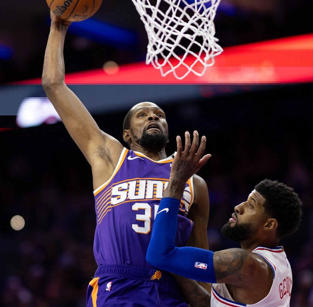 Phoenix Suns forward Kevin Durant (35) drives for a dunk against Philadelphia 76ers forward Paul George (8) during the third quarter at Wells Fargo Center.