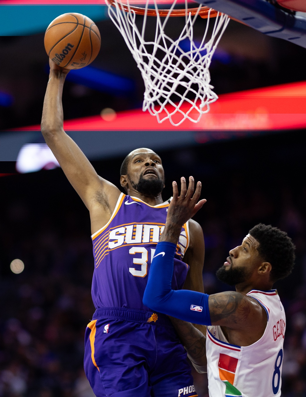 Phoenix Suns forward Kevin Durant (35) drives for a dunk against Philadelphia 76ers forward Paul George (8) during the third quarter at Wells Fargo Center.