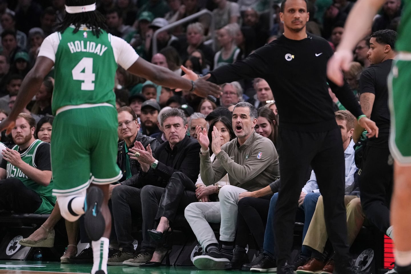 Bill Chisholm, seated right, is the lead partner in a private-equity-backed bid to buy the Boston Celtics for $6.1 billion from the Grousbeck family. He attended a recent playoff game at TD Garden with Wyc Grousbeck.