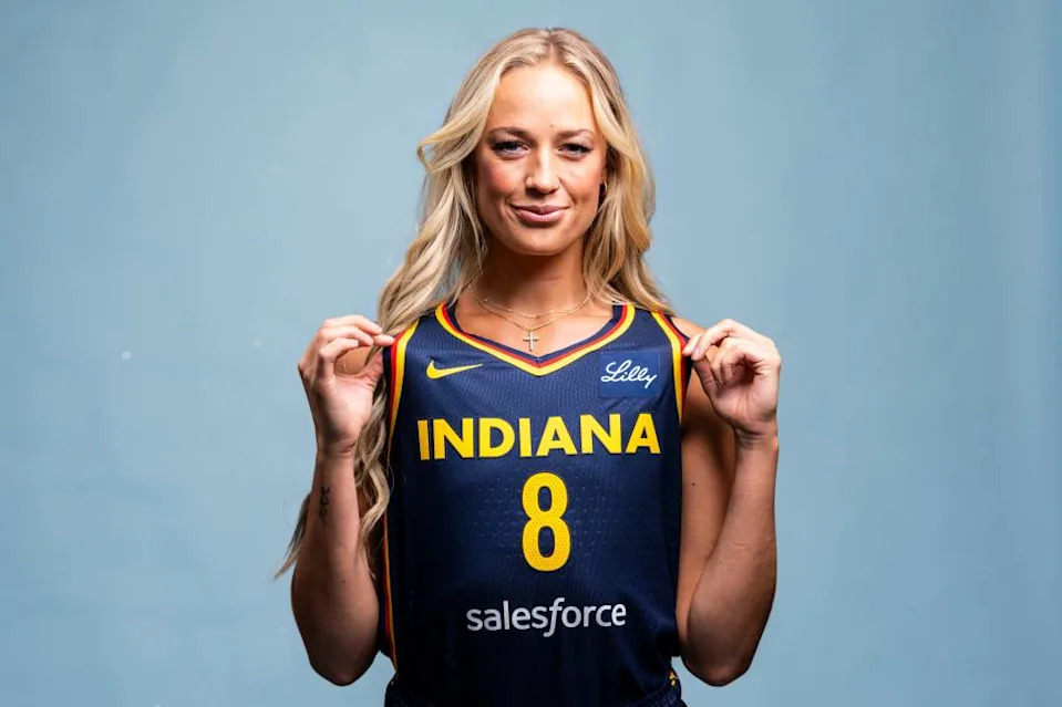 Sophie Cunningham shows off her Indiana Fever jersey at media day. Grace Smith/IndyStar / USA TODAY NETWORK via Imagn Images