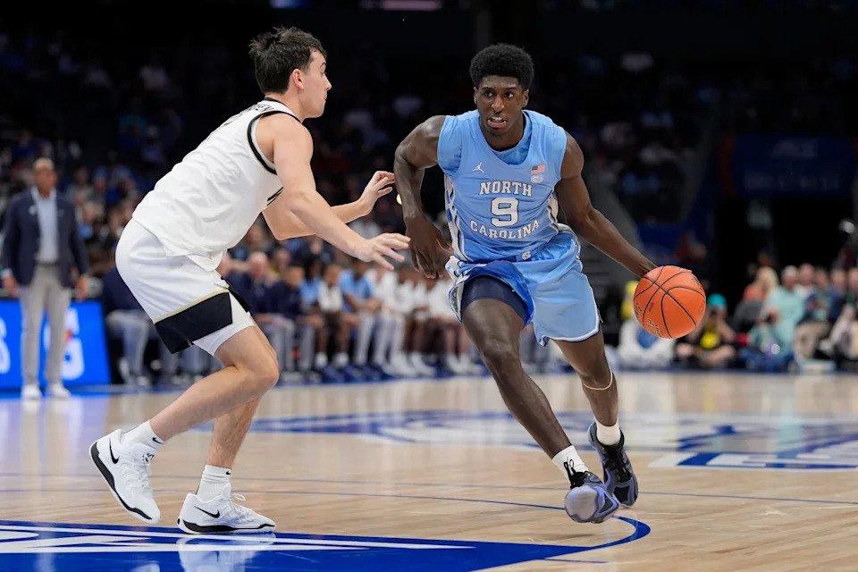 Mar 13, 2025; Charlotte, NC, USA; North Carolina Tar Heels guard Drake Powell (9) goes to the basket against Wake Forest Demon Deacons guard Parker Friedrichsen (7) during the first half at Spectrum Center. Mandatory Credit: Jim Dedmon-Imagn Images