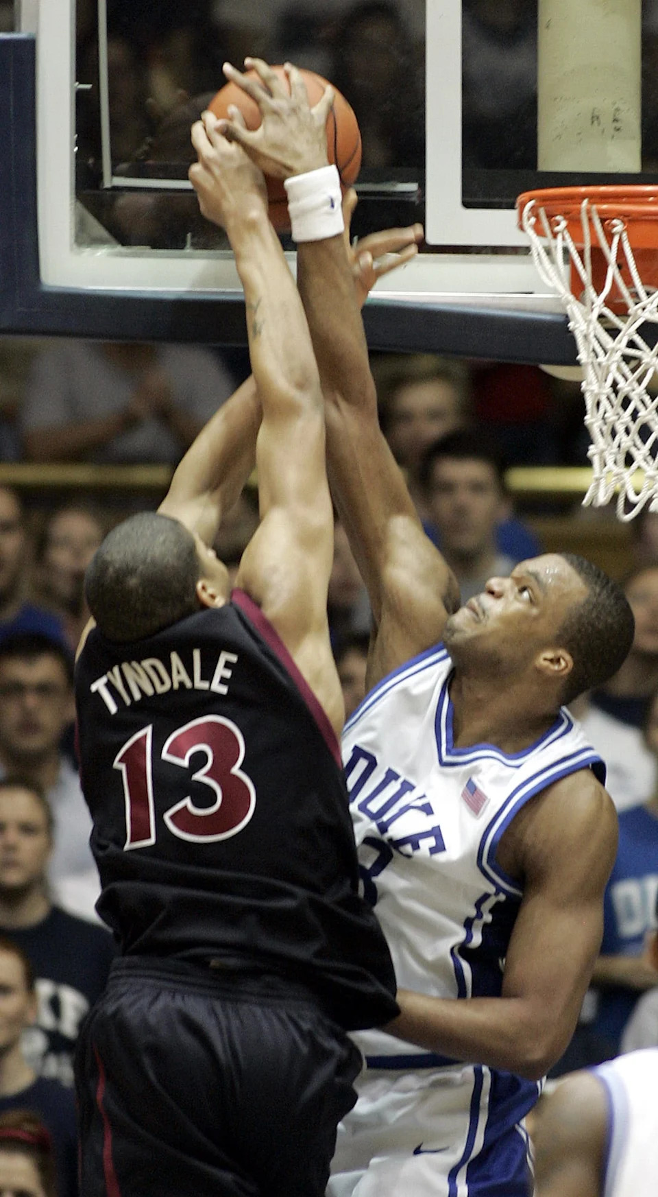 Shelden Williams of the Duke Blue Devils blocks a shot by Mark Tyndale of the Temple Owls.