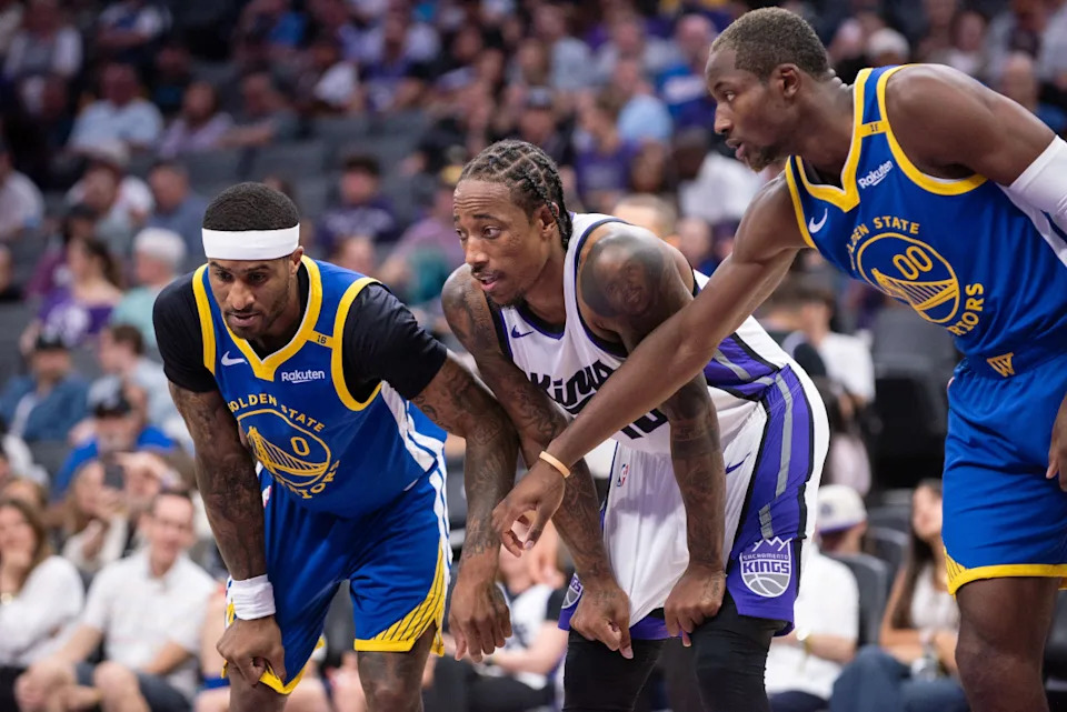 Golden State Warriors guard Gary Payton II (0) and forward Jonathan Kuminga (00) against Sacramento Kings forward DeMar DeRozan (10)© Ed Szczepanski-Imagn Images