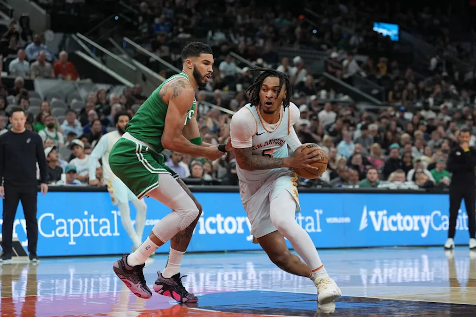 Mar 29, 2025; San Antonio, Texas, USA; San Antonio Spurs guard Stephon Castle (5) dribbles against Boston Celtics forward Jayson Tatum (0) in the first half at Frost Bank Center.© Daniel Dunn-Imagn Images
