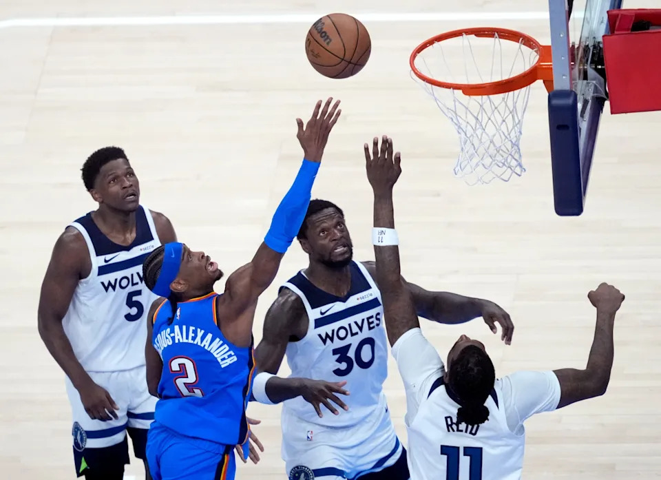 Oklahoma City's Shai Gilgeous-Alexander (2) goes to the basket as Minnesota's Anthony Edwards (5), Minnesota's Julius Randle (30) and Naz Reid (11) defend in the second half of Game 2 Western Conference Finals between the Oklahoma City Thunder and the Minnesota Timberwolves at Paycom Center in Oklahoma City, Thursday, May, 22, 2025.