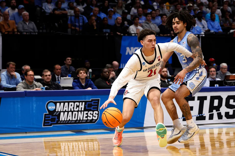 Mar 18, 2025; Dayton, OH, USA; San Diego State Aztecs guard Miles Byrd (21) dribble the ball defended by North Carolina Tar Heels guard Elliot Cadeau (3) in the first half at UD Arena. Mandatory Credit: Rick Osentoski-Imagn Images
