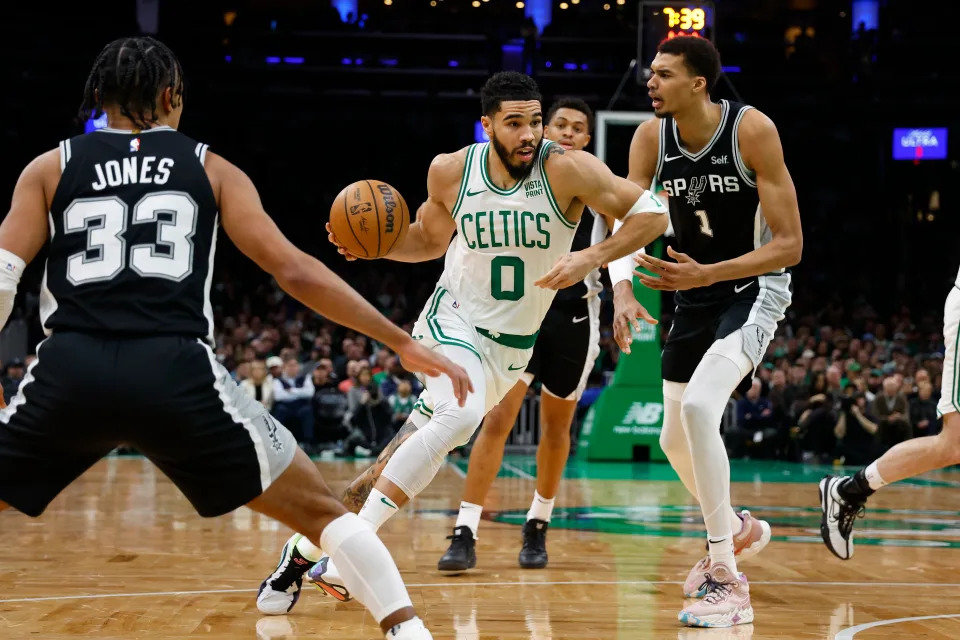 Jan 17, 2024; Boston, Massachusetts, USA; Boston Celtics forward Jayson Tatum (0) drives past San Antonio Spurs center Victor Wembanyama (1) during the second quarter at TD Garden. Mandatory Credit: Winslow Townson-USA TODAY Sports