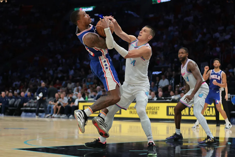 Apr 7, 2025; Miami, Florida, USA; Miami Heat guard Tyler Herro (14) and Philadelphia 76ers guard Lonnie Walker IV (16) battle for possession during the third quarter at Kaseya Center. Mandatory Credit: Sam Navarro-Imagn Images