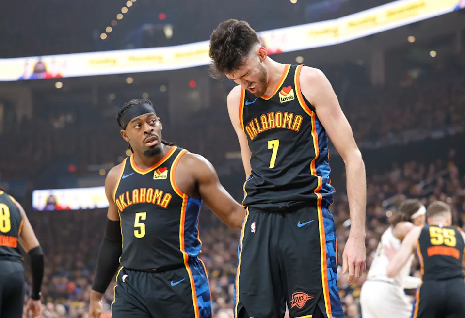 Thunder guard Luguentz Dort (5) checks on forward Chet Holmgren (7) during a game against the Nuggets. Alonzo Adams-Imagn Images