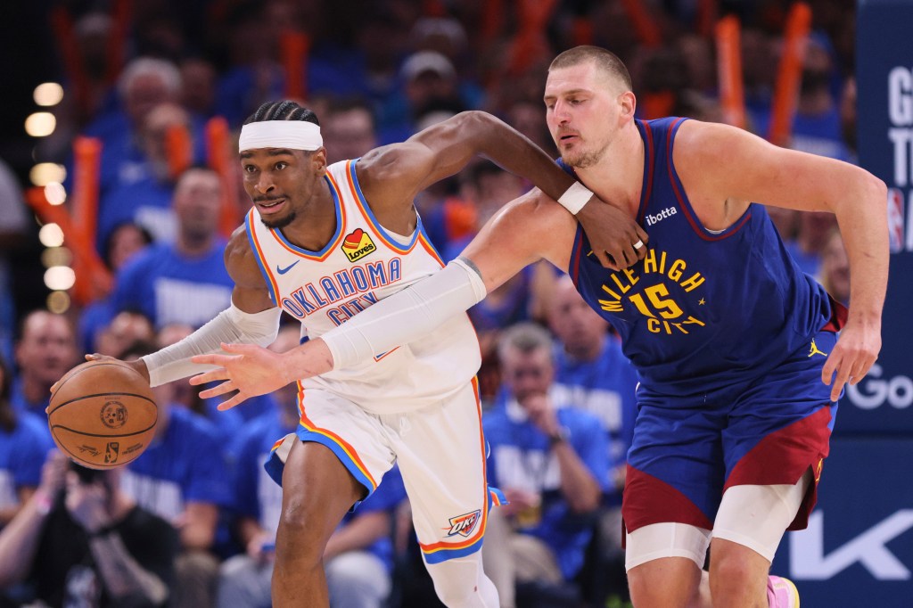 Oklahoma City Thunder's Shai Gilgeous-Alexander, left, advances the ball upcourt under pressure from Denver Nuggets center Nikola Jokic (15) in the second half of Game 5 of an NBA basketball second-round playoff series Tuesday, May 13, 2025, in Oklahoma City.