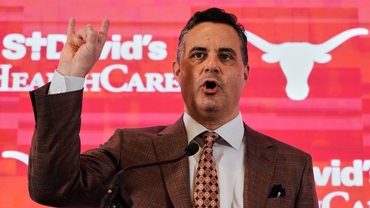 Texas' new coach Sean Miller gives a "Hook'em Horns" sign after he was introduced during an NCAA college basketball news conference in Austin, Texas, Tuesday, March 25, 2025. (AP Photo/Eric Gay, File)