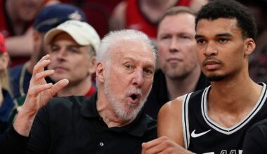 San Antonio Spurs coach Gregg Popovich, left, talks with Victor Wembanyama on the bench during the first half of an NBA basketball game against the Houston Rockets Tuesday, March 5, 2024, in Houston. (AP Photo/David J. Phillip)