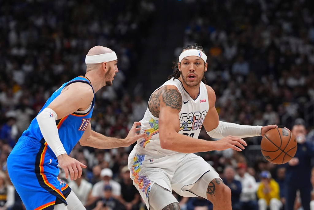 Denver Nuggets forward Aaron Gordon, right, drives to the basket as Oklahoma City Thunder guard Alex Caruso defends in the first half of Game 6 in the Western Conference semifinals of the NBA basketball playoffs Thursday, May 15, 2025, in Denver.
