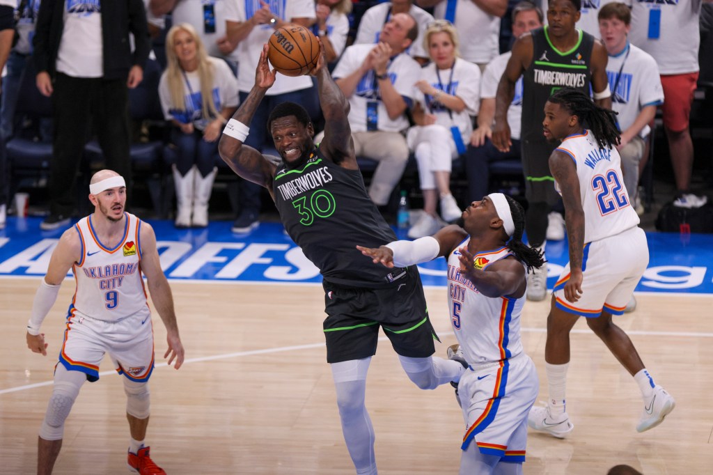 Minnesota Timberwolves forward Julius Randle (30) attempts a pass against Oklahoma City Thunder guard Luguentz Dort (5) during the second half of Game 1 of an NBA basketball Western Conference Finals playoff series Tuesday, May 20, 2025, in Oklahoma City.
