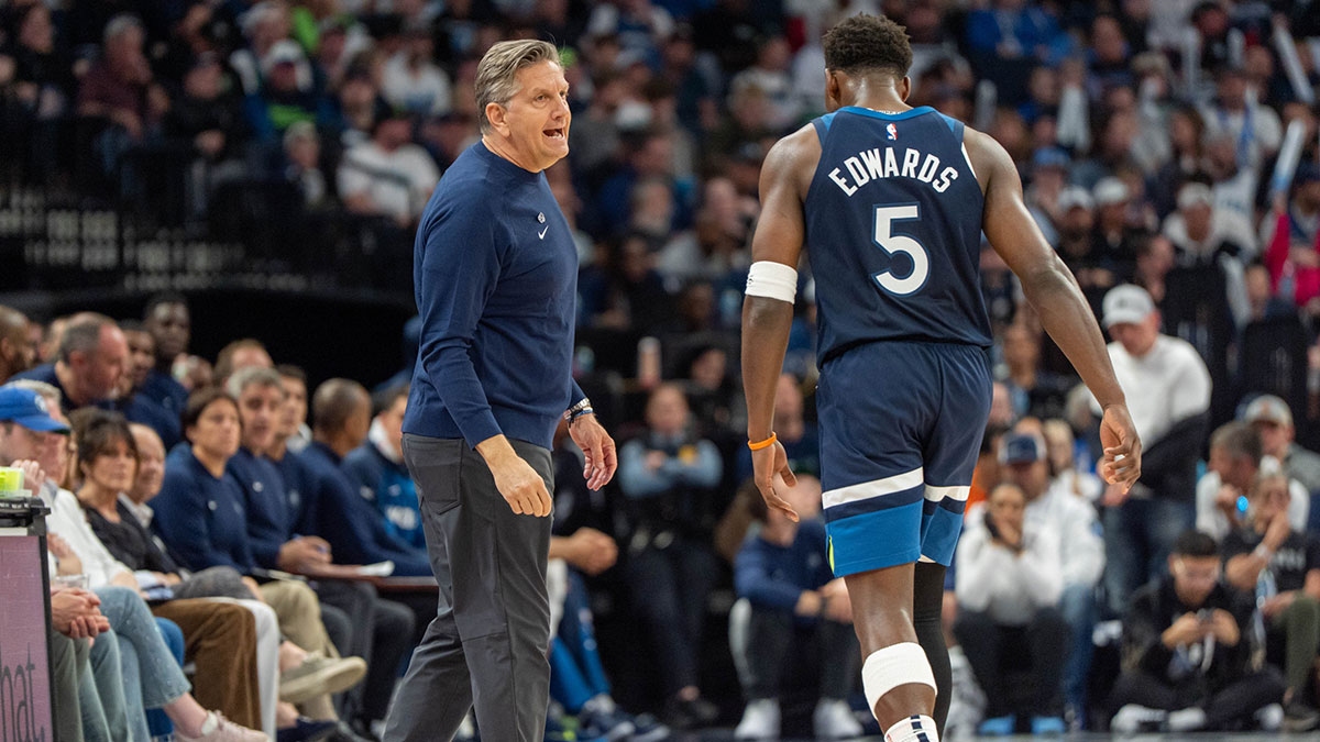 Minnesota Timberwolves head coach Chris Finch tries to calm Minnesota Timberwolves guard Anthony Edwards (5) after a disagreement with the referees while playing the Utah Jazz in the third quarter at Target Center.