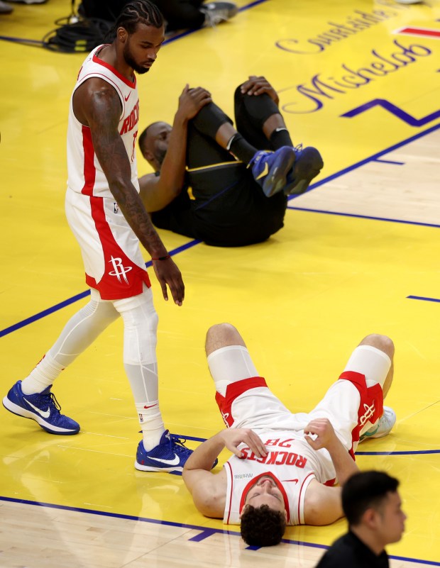 Golden State Warriors' Draymond Green (23) and Houston Rockets' Alperen Sengun (28) end up on their backs in the 1st quarter of Game 6 of the Western Conference First Round NBA Playoffs game at Chase Center in San Francisco, Calif., on Friday, May 2, 2025. (Karl Mondon/Bay Area News Group)