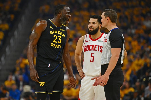 Golden State Warriors' Draymond Green (23) shares his opinions over a call with NBA official JB DeRosa as Houston Rockets' Fred VanVleet (5) watches in the first quarter of Game 6 of the Western Conference First Round NBA Playoffs game at Chase Center in San Francisco, Calif., on Friday, May 2, 2025. (Jose Carlos Fajardo/Bay Area News Group)