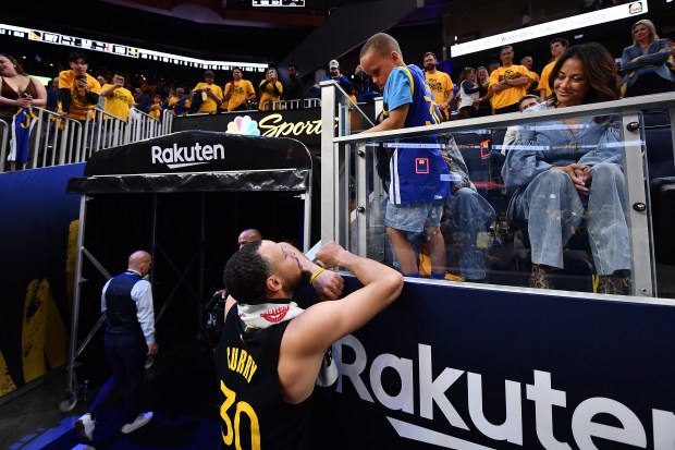 Golden State Warriors' Stephen Curry (30) chats with his son Canon after Game 6 of the Western Conference First Round NBA Playoffs game at Chase Center in San Francisco, Calif., on Friday, May 2, 2025. The Houston Rockets defeated the Golden State Warriors 115-107. (Jose Carlos Fajardo/Bay Area News Group)