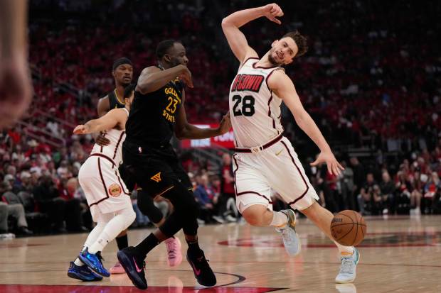 Houston Rockets' Alperen Sengun (28) is fouled by Golden State Warriors' Draymond Green (23) during the first half of Game 7 of an NBA basketball first-round playoff series Sunday, May 4, 2025, in Houston. (AP Photo/Ashley Landis)