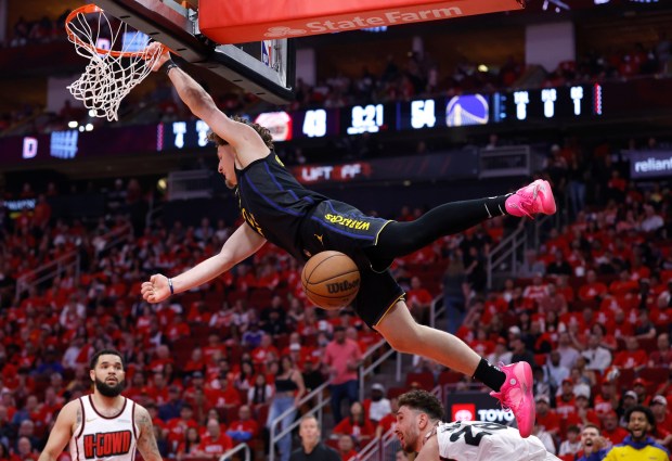 Brandin Podziemski #2 of the Golden State Warriors hangs on the basket after dunking the ball against the Houston Rockets during the third quarter in Game Seven of the Western Conference First Round NBA Playoffs at Toyota Center on May 04, 2025 in Houston, Texas. (Photo by Tim Warner/Getty Images)