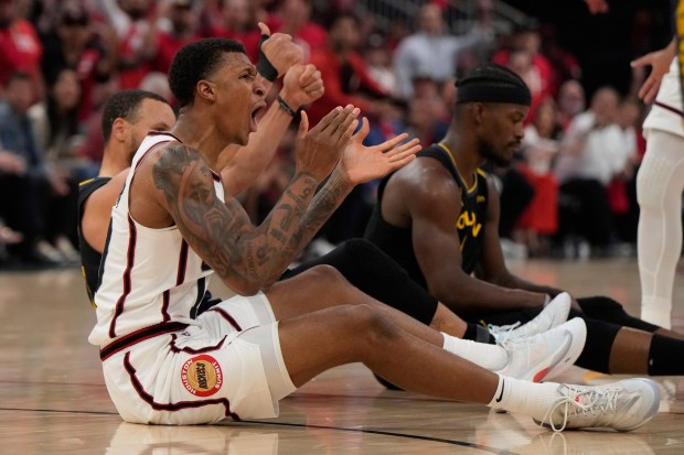 Houston Rockets' Jabari Smith Jr., center, reacts after being fouled by Golden State Warriors' Stephen Curry, back left, during the first half of Game 7 of an NBA basketball first-round playoff series Sunday, May 4, 2025, in Houston. (AP Photo/Ashley Landis)
