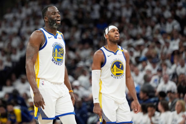 Golden State Warriors forward Draymond Green (23) and Golden State Warriors guard Buddy Hield (7) during the first half of Game 5 of an NBA basketball second-round playoff series, Wednesday, May 14, 2025, in Minneapolis. (AP Photo/Abbie Parr)