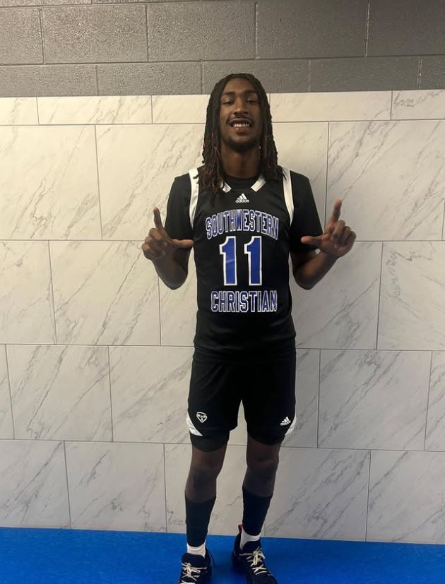 Basketball player in Southwestern Christian jersey #11.