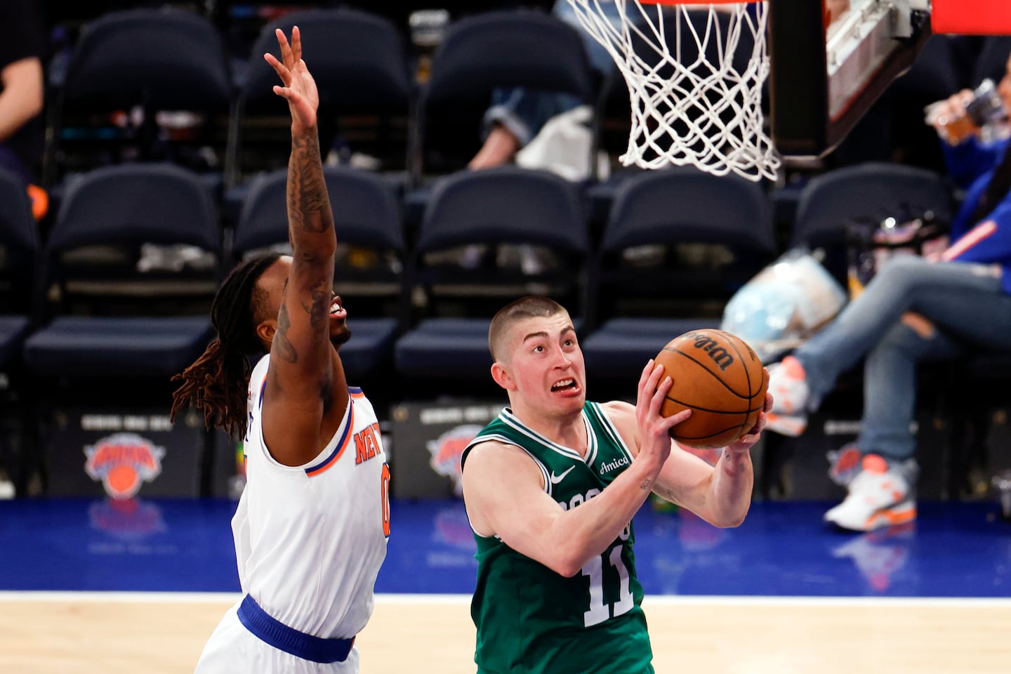 Boston Celtics guard Payton Pritchard (11) drives to the basket past New York Knicks guard Delon Wright (0) during the fourth quarter.