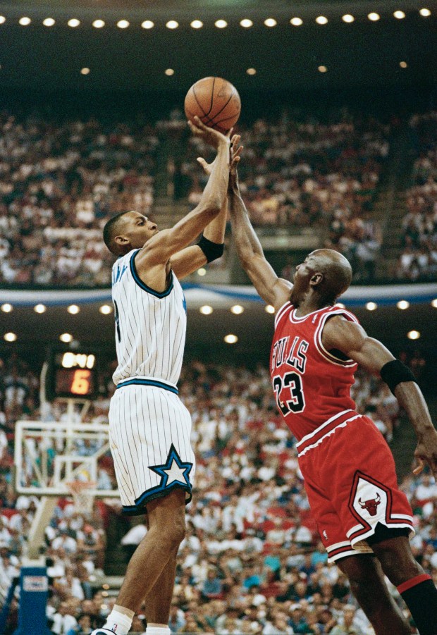 Michael Jordan, wearing his old No. 23, stretches against Orlando Magic's Anfernee Hardaway (1) in the first half of their NBA Eastern Semi-Finals game at Orlando, Fla., on May 10, 1995. (Steve Simoneau/AP)