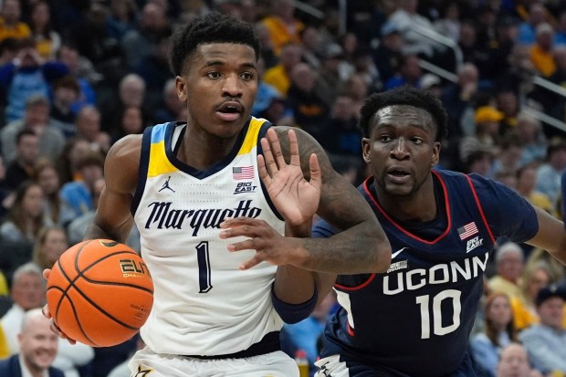 Marquette's Kam Jones is fouled by Connecticut's Hassan Diarra on March 6, 2024, in Milwaukee. (AP Photo/Morry Gash)