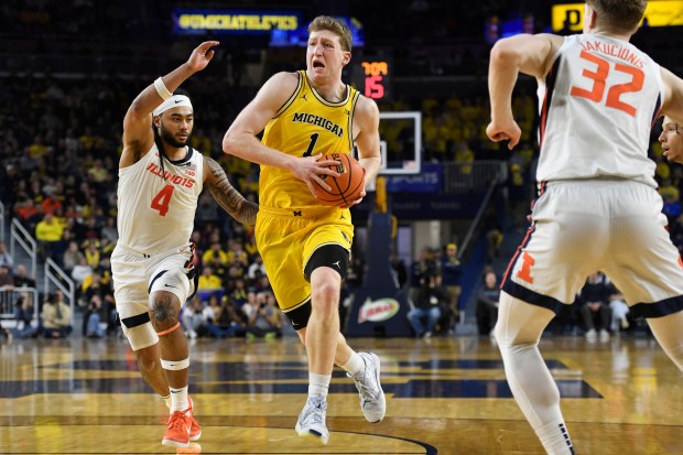 Michigan's Danny Wolf drives to the basket past Illinois guard Kylan Boswell on March 2, 2025, in Ann Arbor, Mich. (AP Photo/Jose Juarez)