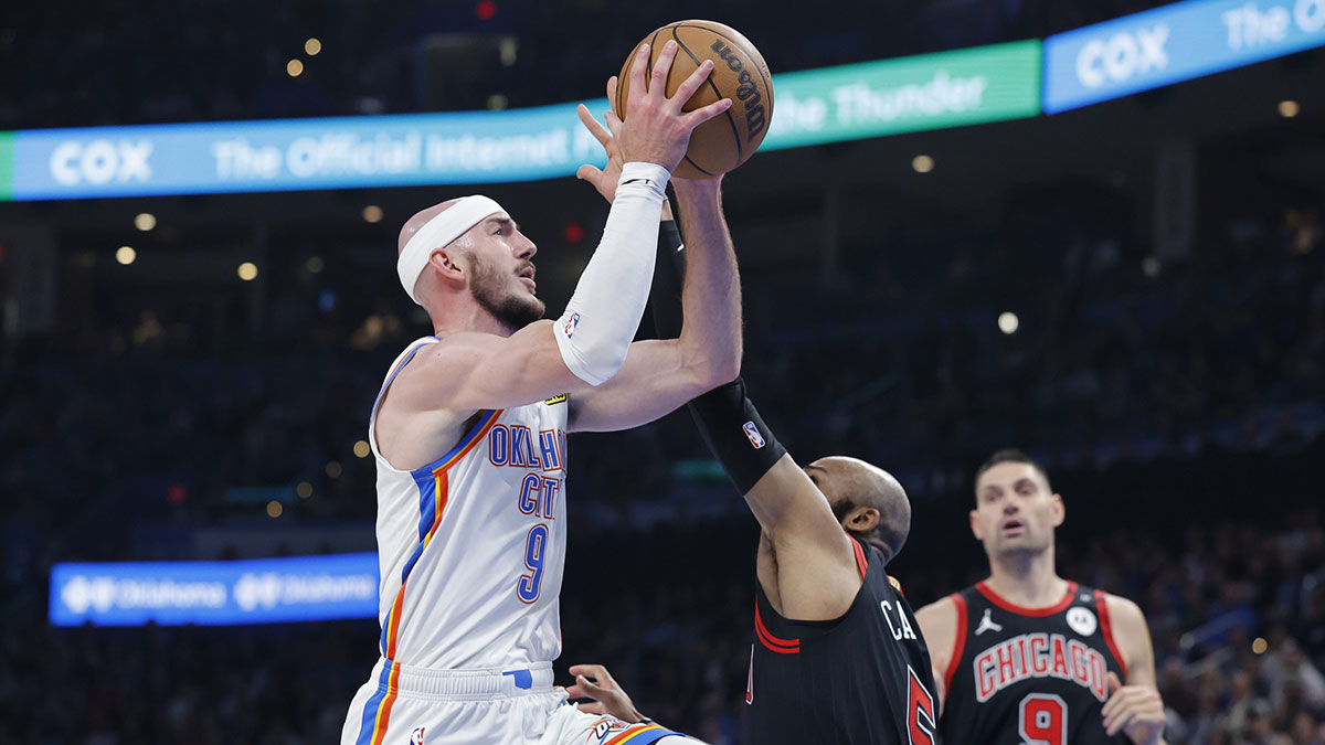 Oklahoma City Thunder guard Alex Caruso (9) goes up for a basket as Chicago Bulls guard Jevon Carter (5) defends during the second quarter at Paycom Center.