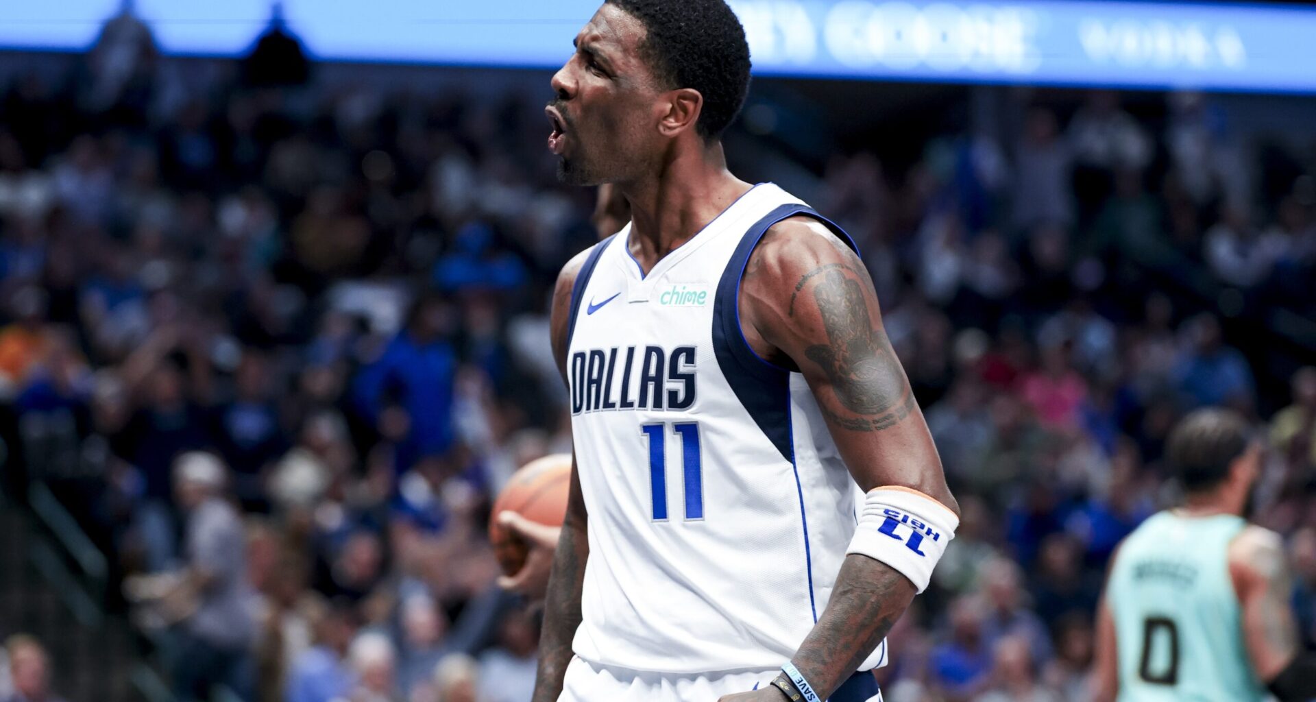 Dallas Mavericks guard Kyrie Irving (11) reacts after scoring against the Charlotte Hornets during the second half at American Airlines Center.