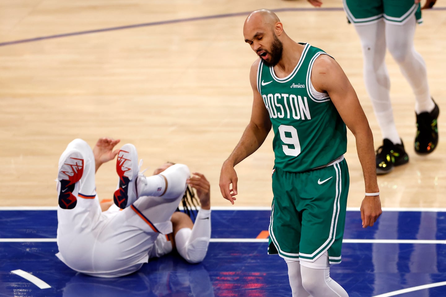 Boston Celtics guard Derrick White (9) reacts after fouling New York Knicks guard Jalen Brunson (left) during the first quarter.